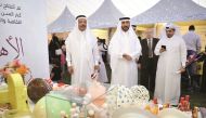 Mubarak bin Abdul-Aziz Al Khalifa, CEO of Qatar Foundation for Elderly People Care (Ihsan), taking a tour of stalls with other officials during the celebration of World Day for Elderly at Aspire Park yesterday. Abdul Basit / The Peninsula