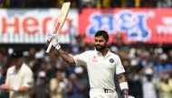 India's batsman and captain Virat Kohli celebrates after scoring a double century during the second day of third test cricket match between India and New Zealand at The Holkar Cricket Stadium in Indore on October 9, 2016. (AFP / PUNIT PARANJPE)
