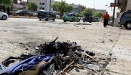 The remains from an explosion attack, which targeted an Ashura procession commemorating the death of Imam Hussain, the grandson of Prophet Muhammad, are seen on the ground in the Iraqi capital Baghdad on October 9, 2016. / AFP / SABAH ARAR