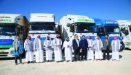 Officials from RAF and Turkish humanitarian organisation IHH posing in front of trucks carrying 3,200 tonnes of flour from Turkey to Syria.