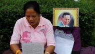 A well-wisher wears a pink shirt as she prays in front of a portrait of Thailand's King Bhumibol Adulyadej at Siriraj Hospital in Bangkok, Thailand, October 11, 2016. Reuters/Chaiwat Subprasom