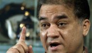 Outspoken scholar of China's Uighur minority, Ilham Tohti, shown here in 2013, gestures as he speaks during an interview at his home in Beijing, China. (Andy Wong/AP)