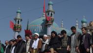 Afghan mourners offer funeral prayers for a victim in Kabul on October 12, 2016, who was killed in an attack by gunmen inside the Karte Sakhi shrine late on October 11.  / AFP / SHAH MARAI.