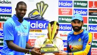 Pakistani cricket captain Misbah-Ul-Haq (right) and his West Indies counterpart Jason Holder hold the Test series trophy at the Dubai International Cricket Stadium in the Gulf Emirate, in the UAE
