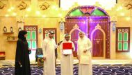 A senior citizen being honoured by the QRCS officials.