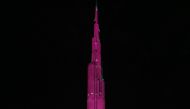 Dubai's Burj Khalifa, the world's tallest tower, is lit up in pink to raise awareness and funds to fight breast cancer, in the Gulf Emirate of Dubai on October 13, 2016. (AFP / KARIM SAHIB) 