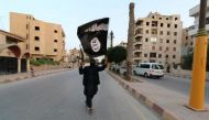 A member loyal to the Islamic State waves an ISIS flag in Raqqa.  (Reuters / File photo)