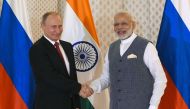 Indian Prime Minister Narendra Modi (R) shakes hands with Russian President Vladimir Putin ahead of the Indo-Russia Annual Summit at Taj Exotica Hotel in Goa. AFP/Prakash Singh