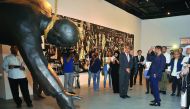 Journalists look at an exhibit by Iraqi-Canadian artist Mahmoud Obaidi at Katara yesterday. Pic: Baher Amin/ The Peninsula