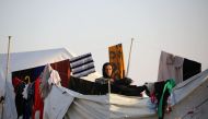 A woman poses at a refugee camp housing Iraqi families who fled fighting in the Mosul area on October 17, 2016 in the northeastern town of al-Hol in Syria's Hasakeh province. The battle to retake the Iraqi city of Mosul from jihadists could unleash a mass