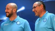 Napoli's Italian head coach Maurizio Sarri (R) and Napoli's Spanish goalkeeper Pepe Reina smile during a press conference at the SSC Napoli headquarters on October 18, 2016, on the eve of the UEFA Champions League Group B football match SSC Napoli vs Besi