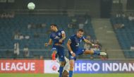 Mumbai City FC midfielder Sehnaj Singh (L) and Lucian Goian vies for the ball with Delhi Dynamos FC player during the Indian Super League (ISL) football match between Delhi Dynamos FC and Mumbai City FC at The Jawaharlal Nehru Stadium in New Delhi on Octo