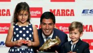 Barcelona's striker Luis Suarez, his daughter Delfina and son Benjamin, pose with his 2016 European Golden Shoe soccer trophy, which is awarded to the top goalscorer in Europe's domestic leagues, during an awards ceremony in Barcelona, Spain October 20, 2