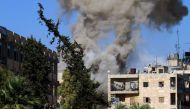 Smoke rises from reported opposition fire from buildings in an eastern government-held neighbourhood of the northern Syrian city of Aleppo on October 20, 2016 as clashes erupted in an area designated as a humanitarian corridor for civilians to leave the e