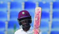 West Indies’ batsman Kraigg Brathwaite raises his bat after scoring 50 runs on the fourth day of the second Test against Pakistan at the Sheikh Zayed Cricket Stadium in Abu Dhabi, yesterday.