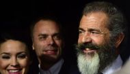Mel Gibson (R), actor-turned-director for this film, smiles on arrival for the Los Angeles special screening of 'Hacksaw Ridge' at the Samuel Goldwyn Theater in Beverly Hills, California on October 24, 2016. AFP / Frederic J. BROWN