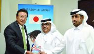 Japanese Ambassador Shingo Tsuda (left) donating a book to Ibrahim Al Sayed, Director of Public Libraries & Heritage Department (centre) and Abdul Rahman Al Hatmi, Director of Supply Department, Qatar Public library.
