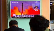 People watch a television news report showing file footage of North Korea's missile launch at a railway station in Seoul on October 20, 2016 (AFP Photo/Jung Yeon-Je)