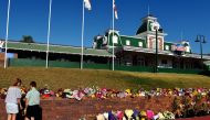 Members of the public leave floral tributes outside the main entrance to Dreamworld located on the Gold Coast, Australia October 26, 2016 after Tuesday's tragedy that saw four people killed on the Thunder River Rapids Ride at Australia's biggest theme par