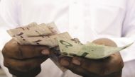 A Saudi businessman counting money. (File Photo)