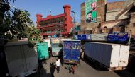 A boy holding a flag walks past trucks, used to block a venue of a planned protest gathering organised by Awami Muslim League, a political ally party of Imran Khan's Pakistan Tehreek-e-Insaf (PTI), in Rawalpindi, Pakistan. Reuters/Faisal Mahmood