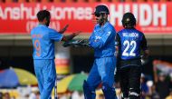 Indian bowler Amit Mishra (L) celebrates with team captain Mahendra Singh Dhoni after dismissing New Zealand batsman and captain Kane Williamson during the fourth one day international (ODI) cricket match between India and New Zealand at The Jharkhand Sta