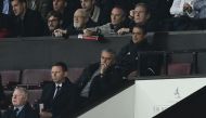 Manchester United's Portuguese manager Jose Mourinho (C) sits in the Directors Box with spectators after being sent off from the pitchside during the English Premier League football match between Manchester United and Burnley at Old Trafford in Manchester