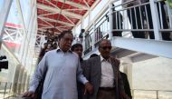 In this photograph taken on June 1, 2015, Pakistan Information Minister Pervez Rasheed (L) steps down from the escalator during a visit to Metro Bus station in Islamabad. Pakistan prime minister Nawaz Sharif on October 29, 2016, removed a key minister of 