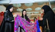 Ibteihaj Al Ahmadani, Head of Health Committee at Qatar Chamber, and Qomasha Al Jabor, Head of Exhibition Technical Support Section at QTA, during the grand opening of Heya Arabian Fashion Exhibition which took place at DECC on Thursday. Below: Creations 