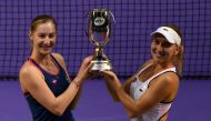 Ekaterina Makarova (L) and Elena Vesnina of Russia (R) pose with the trophy after their victory in the women's doubles final against Bethanie Mattek-Sands of the US and Lucie Safarova of the Czech Republic at the WTA Finals tennis tournament in Singapore 