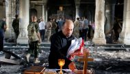 An Iraqi Christian prepares for the first Sunday mass at the Grand Immaculate Church since it was recaptured from Islamic State in Qaraqosh, near Mosul in Iraq October 30, 2016. REUTERS/Ahmed Jadallah