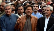 Pakistani opposition leader Imran Khan (C) talks to media outside his house in Islamabad, Pakistan, October 28, 2016. REUTERS/Stringer.