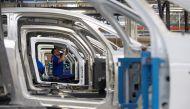 An employee works on the automobile assembly line of Bluecar electric city cars at Renault car maker factory in Dieppe, western France, September 1, 2015. REUTERS/Philippe Wojazer