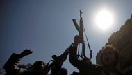 Pro-Houthi protesters wave their weapons as they shout slogans against a U.N.-proposed peace plan for Yemen during a demonstration outside a hotel where the U.N. envoy for Yemen, Ismail Ould Cheikh Ahmed, is staying in Sanaa, Yemen, November 5, 2016. REUT