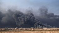 Smoke rises from burning oil wells in Qayyarah, south of Mosul, on November 4, 2016, during operation by Iraqi forces to retake the main hub city from the Islamic State (IS) group jihadists. Elite Iraqi forces pushed deep into the streets of Mosul on Frid