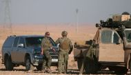 U.S. fighters stand near military vehicles, north of Raqqa city, Syria November 6, 2016. REUTERS/Rodi Said
