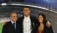 Real Madrid's Portuguese forward Cristiano Ronaldo (C) club president Florentino Perez and Portugal's forward Cristiano Ronaldo's mother Maria Dolores dos Santos Aveiro (R) pose during the official presentation of Ronaldo's contract renewal, in the presid