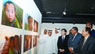 The Ambassador of China to Qatar, Li Chen; Director of Arts in Residence, Fire Station, Khalifa Ahmed Al Obaidly; and other diplomats viewing the photography exhibition 