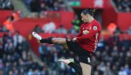 Manchester United's Swedish striker Zlatan Ibrahimovic jumps and kicks the air as he celebrates scoring his team's second goal during the English Premier League football match between Swansea City and Manchester United at The Liberty Stadium in Swansea, s