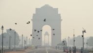 In this photograph taken on October 28, 2016, Indian pedestrians walk near the India Gate monument amid heavy smog in New Delhi. India's top court on November 8 gave the federal government two days to chalk out a plan to tackle alarming levels of smog in 