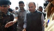 Indian Finance Minister Arun Jaitley (R) arrives at the offices of the Ministry of Finance in New Delhi on November 9, 2016. Cash machines ran dry and stocks tumbled in India after Prime Minister Narendra Modi ordered the withdrawal of 500 and 1,000 rupee