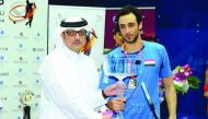 PSA World Championship winner Ramy Ashour is seen with Nabeel Ali bin Ali, President of Qatar Squash Federation after winning the world championship in Doha in this file picture of November 22, 2014.