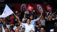 People wave Tunisian and 