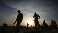 Members of the Iraqi forces stand on their BMP-1 infantry fighting vehicles as they hold a position in the village of Jarif, some 45 kilometres south of Mosul, on November 12, 2016, after retaking it from Islamic State (IS) group jihadists. / AFP / SAFIN 