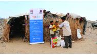 Two children receiving education and food supplies provided by RAF in Yemen.