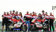 Riders and officials of the QMMF Racing Team pose for a photograph after the Valenciana Grand Prix at the Ricardo Tormo racetrack in Cheste, Valencia, Spain on Sunday.
