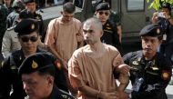 Suspects of the August 17 Bangkok blast, Bilal Mohammed (also known as Adem Karadag) and Yusufu Mieraili are escorted as they arrive at the military court in Bangkok, Thailand, November 24, 2015. REUTERS/Chaiwat Subprasom/File Photo