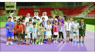 Officials representing the Qatar Tennis Federation (QTF) and ExxonMobil Qatar taking a picture with young participants in the 2016 Qatar ExxonMobil Junior Open, at the Khalifa Tennis and Squash Complex, in Doha on Monday. 
