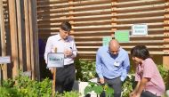 A Doha English Speaking School (DESS) student with Qatar Green Building Council (QGBC) experts during the launch of ‘DESS Community Garden’.