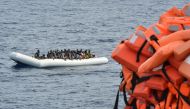 This file photo taken on November 5, 2016 shows migrants and refugees on a rubber boat waiting to be evacuated during a rescue operation by the crew of the Topaz Responder, a rescue ship run by Maltese NGO 